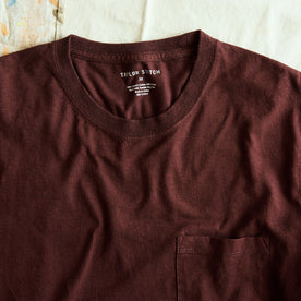 stylized shot of the neck opening on The Cotton Hemp Long Sleeve Tee in Burgundy