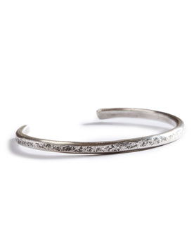 Material shot of the hammered texture on The Hammered Cuff in Silver, Accessories by Taylor Stitch