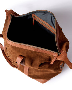 flatlay of The Weekender Duffle in Chocolate Roughout, shown open, Accessories by Taylor Stitch