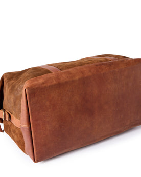 flatlay of The Weekender Duffle in Chocolate Roughout, showing the reinforced leather bottom, Accessories by Taylor Stitch