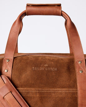 material shot of the leather handles and strap on The Weekender Duffle in Chocolate Roughout, Accessories by Taylor Stitch