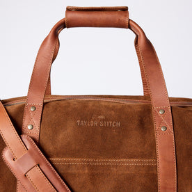 material shot of the leather handles and strap on The Weekender Duffle in Chocolate Roughout