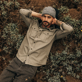 fit model lying on the ground in The Saddler Shirt in Smoked Olive Twill