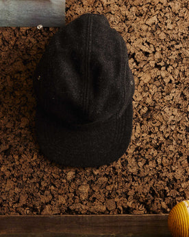 editorial image of The 5-Panel Cap in Heather Coal Wool Blend hanging, Accessories by Taylor Stitch