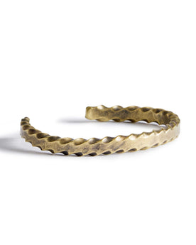material shot of the side of The Twisted Cuff in Brass, Accessories by Taylor Stitch