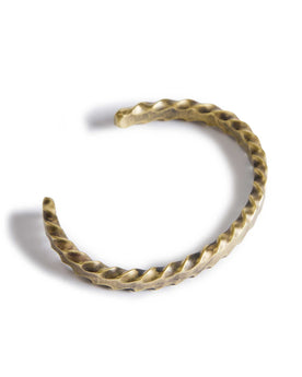 material shot of the top of The Twisted Cuff in Brass, Accessories by Taylor Stitch