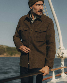 fit model standing on a boat wearing The Maritime Shirt Jacket in Ranger Twill Wool, Outerwear by Taylor Stitch