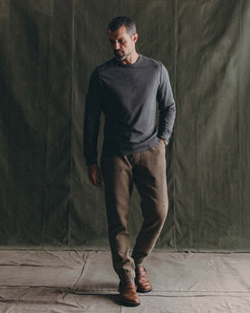 fit model walking wearing The Organic Cotton Long Sleeve Tee in Faded Black, Knits by Taylor Stitch
