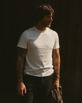 fit model walking wearing The Organic Cotton Tee in Vintage White