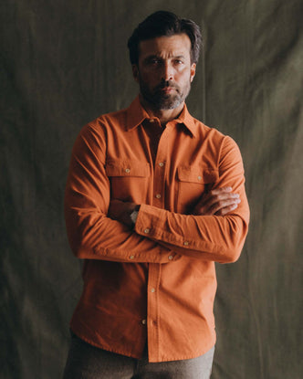 fit model posing in The Yosemite Shirt in Summit Orange