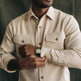 fit model buttoning the cuffs on The Point Shirt in Natural Sashiko
