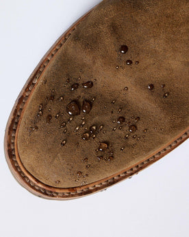 material shot of The Ranch Boot in Golden Brown Waxed Suede with water droplets on the suede, Footwear by Taylor Stitch