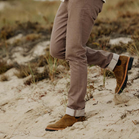fit model walking on a log in The Slim All Day Pant in Silt Broken Twill