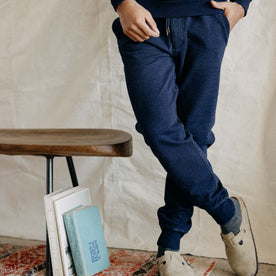 fit model crossing his legs in The Sunset Pant in Indigo Terry
