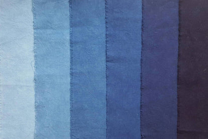 a shot of fabric dyed in different tones of indigo