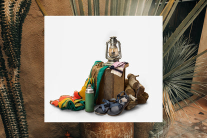 The Z1 USA Classic Sandal with a blanket, a thermos, a pile of logs and a lamp