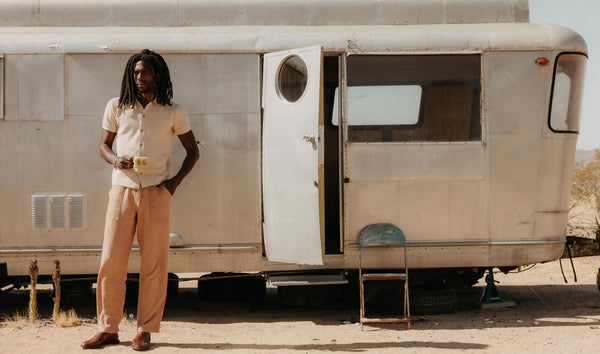 fit model sitting wearing The Breakwater Pant in Chili Stripe Linen
