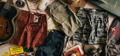 Flat lay of our three Adventure Shorts, folded neatly with some outdoor gear.