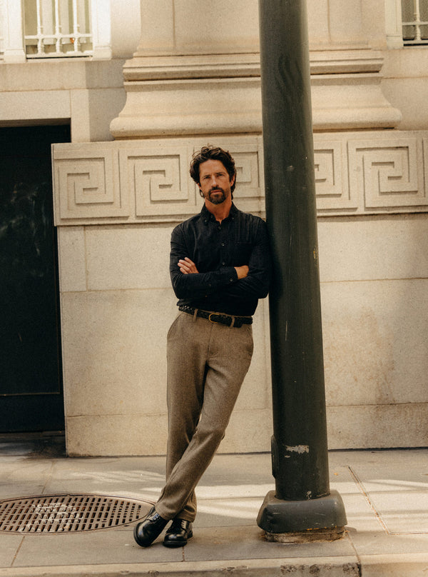 Model leaning against a lamp post