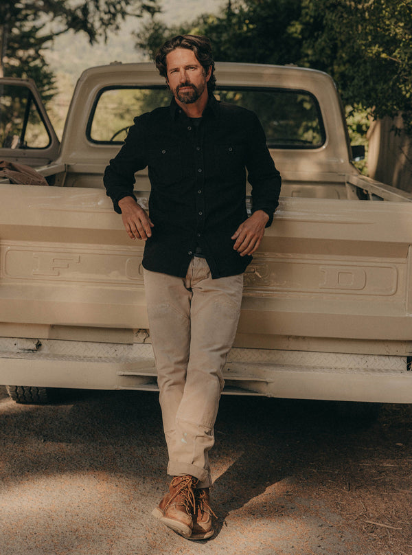 Model leaning against the back of a truck