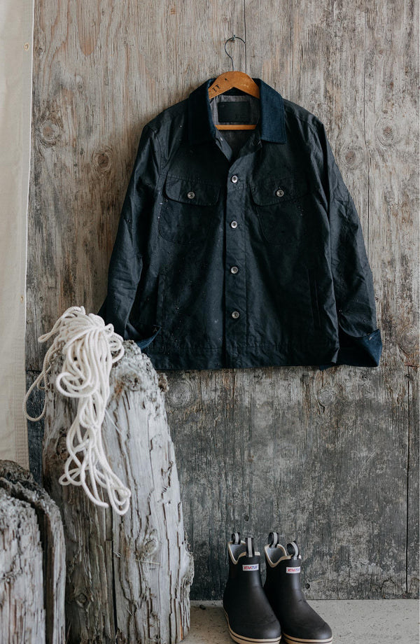 editorial image of The Long Haul Jacket in Coal Dry Wax hanging