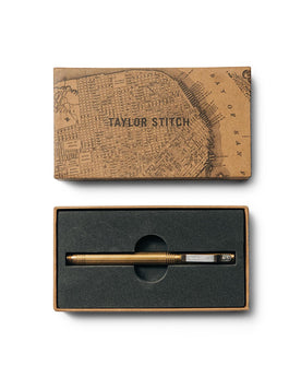 flatlay of The Pen in Brass in a Taylor Stitch gift box