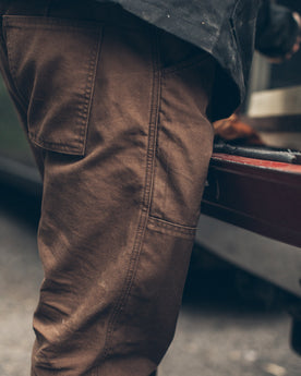 Our fit model working on his truck, Pants by Taylor Stitch