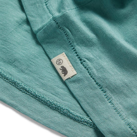 material shot of the TS label on The Cotton Hemp Tee in Teal