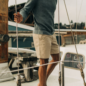 fit model holding a line while wearing The Morse Short in Sand Linen