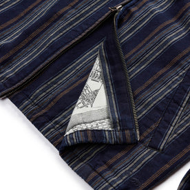 material shot of the two way zipper and SF map print pocketing on The Clark Jacket in Indigo Stripe