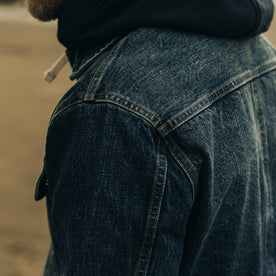 fit model showing left shoulder of The Long Haul Jacket in Sawyer Wash Organic Selvage