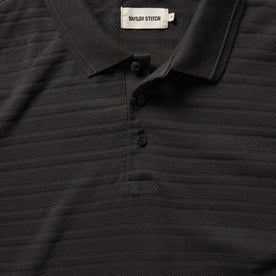material shot of collar and placket of The Polo in Dark Charcoal Jacquard