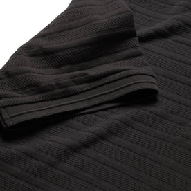 material shot of ribbed sleeve hem of The Polo in Dark Charcoal Jacquard