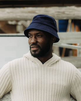 fit model posing in The Bucket Hat in Washed Navy Twill, Accessories by Taylor Stitch
