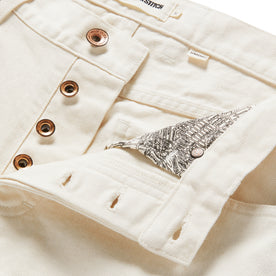 material shot of open button fly of The Democratic Jean in Natural Organic Selvage