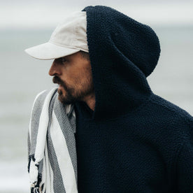 fit model showing the side of The Nomad Hoodie in Navy Sherpa
