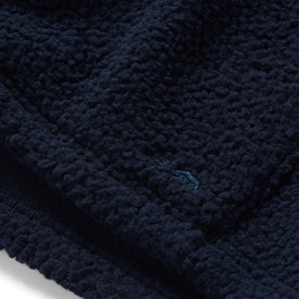 material shot of the TS logo on The Nomad Hoodie in Navy Sherpa 