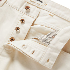 material shot of open button fly of The Slim Jean in Natural Organic Selvage