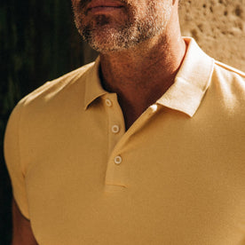 fit model wearing The Pique Polo in Straw, chest close up