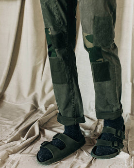material shot of The Atelier and Repairs Chino in Olive, model standing diagonal, Bottoms by Taylor Stitch