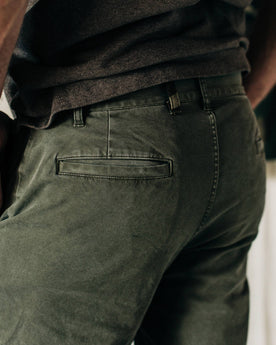 material shot of The Atelier and Repairs Chino in Olive, side shot on model, Bottoms by Taylor Stitch