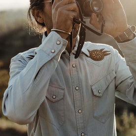 fit model taking a photo in The Embroidered Western Shirt in Washed Selvage