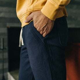 fit model standing with his hands in the pockets of The Fillmore Pant in Dark Navy