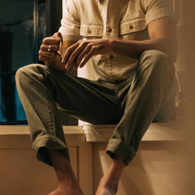 fit model sitting in The Democratic All Day Pant in Arid Eucalyptus Canvas