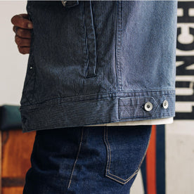 fit model showing the hem of The Long Haul Jacket in Washed Indigo Stripe