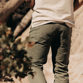 fit model showing the back of The Slim All Day Pant in Arid Eucalyptus Canvas