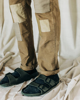 material shot of The Atelier and Repairs Chino in British Khaki, model wearing chinos with birks, Bottoms by Taylor Stitch