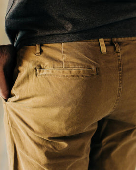 material shot of The Atelier and Repairs Chino in British Khaki, model wearing chinos—back detail, Bottoms by Taylor Stitch