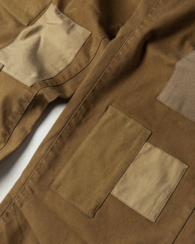 material shot of The Atelier and Repairs Chino in British Khaki, patches on front, Bottoms by Taylor Stitch