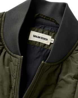 material shot of the neck opening on The Able Vest in Quilted Army, Outerwear by Taylor Stitch